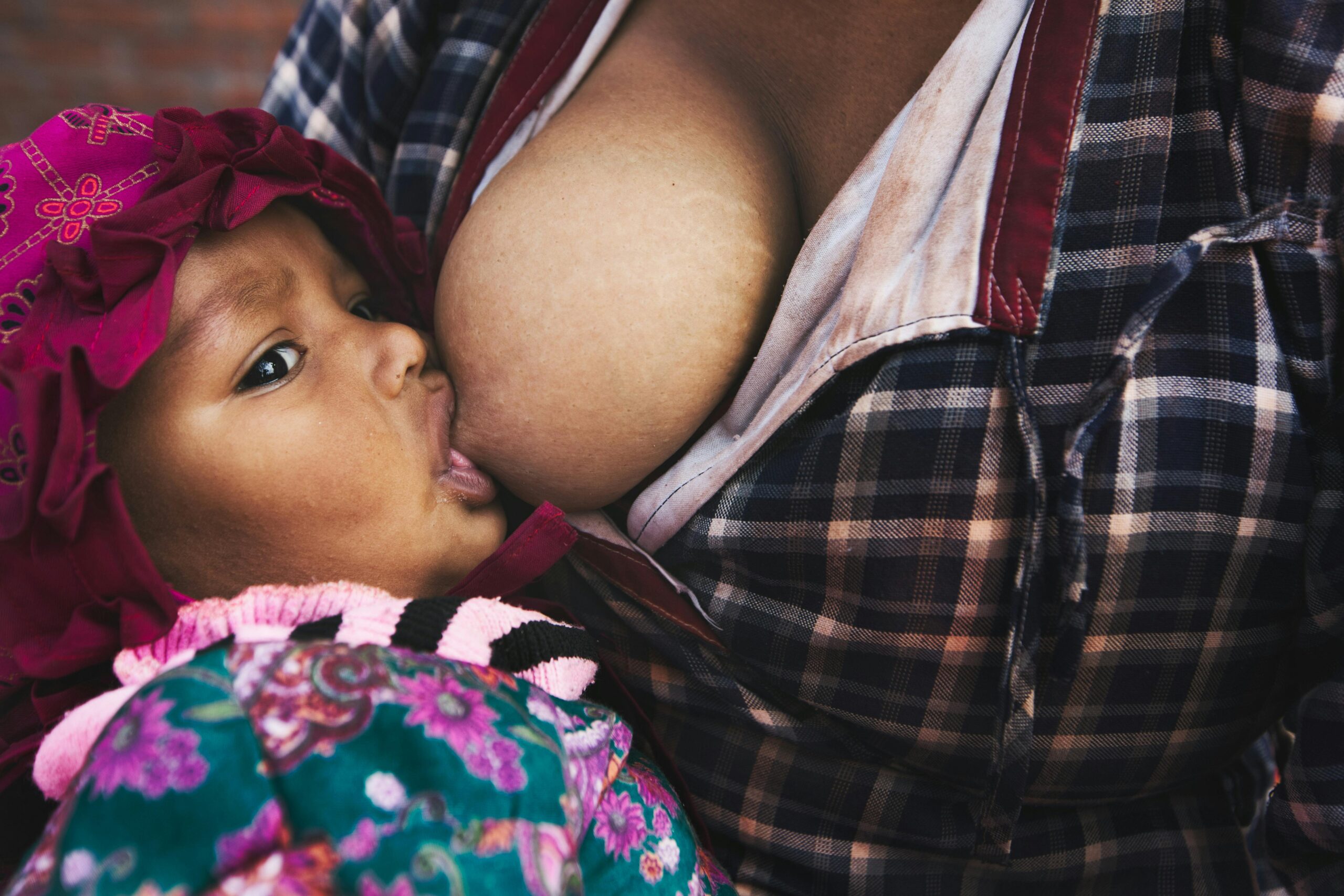 A heartwarming scene of a child breastfeeding, capturing maternal love and intimacy.